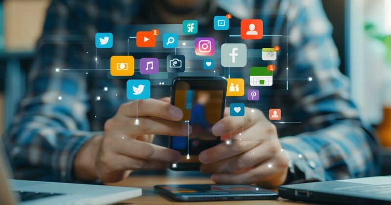 man-is-playing-his-phone-with-icons-screen